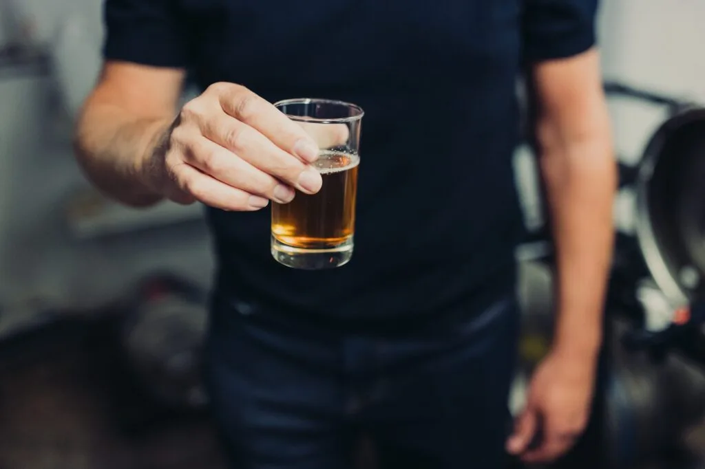 Man holding a beer tasting glass
